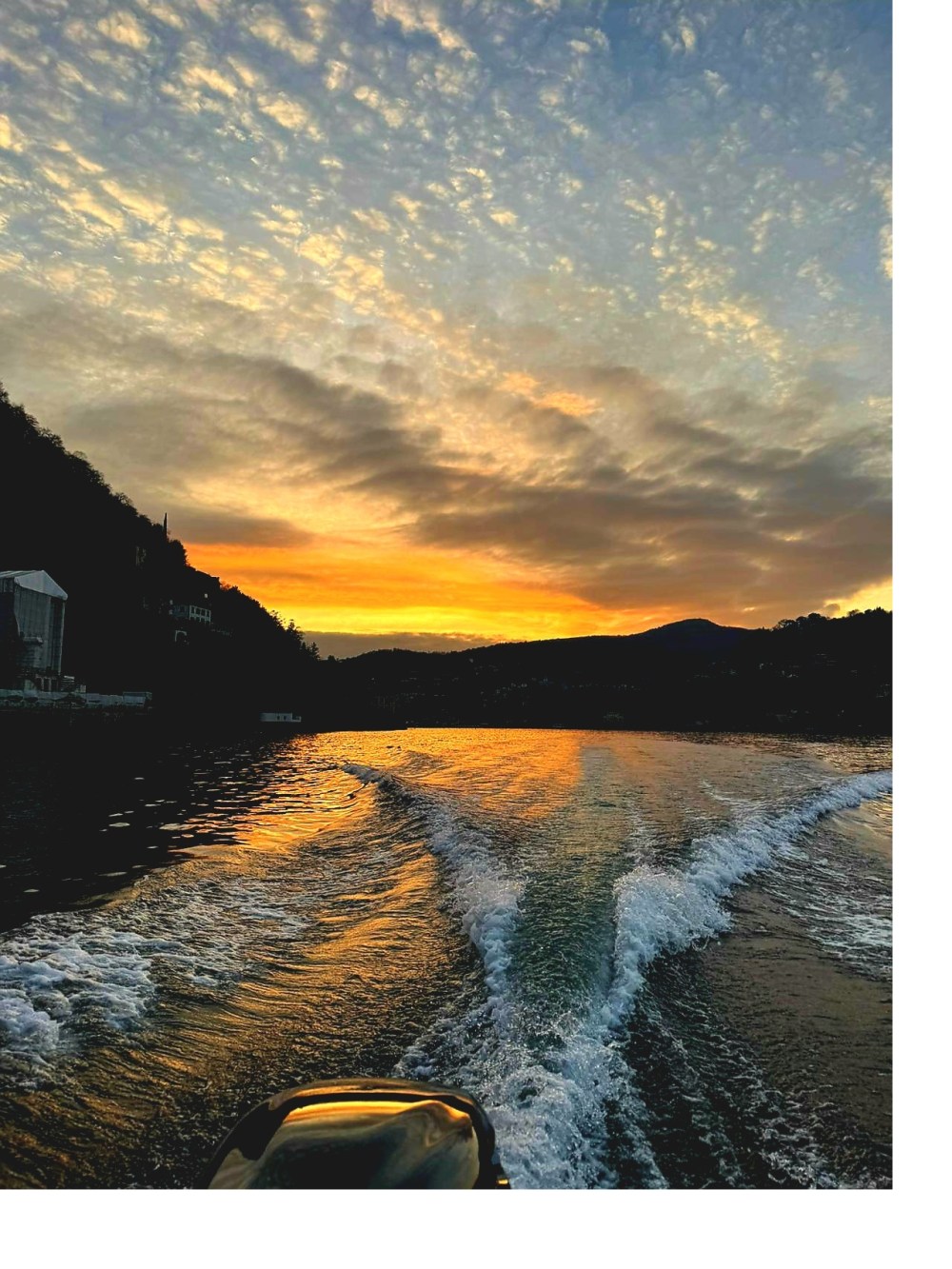 Golden sunset during a Lake Como boat tour with wake on the water